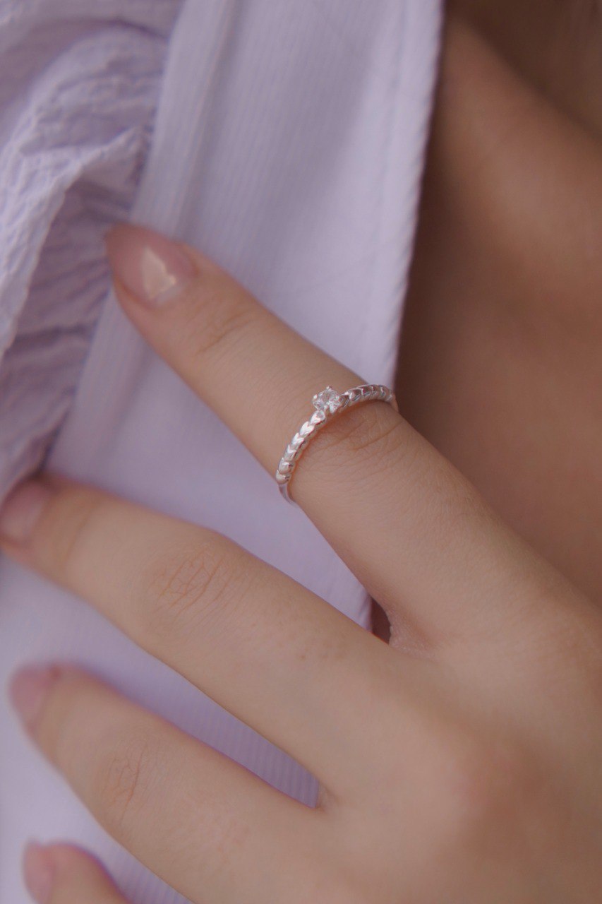 Solitaire Ring with Sparkling Center and Heart Details